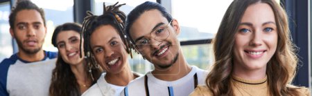portrait of successful multiethnic team smiling at camera in coworking office, horizontal banner