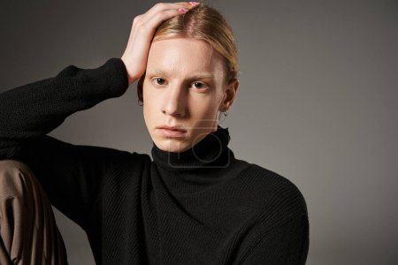 Photo for Good looking non binary model in stylish black turtleneck posing and looking at camera, fashion - Royalty Free Image
