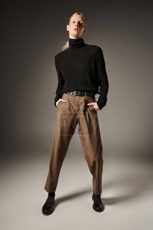 Photo for Young non binary person in stylish attire posing with hands in pockets and looking at camera - Royalty Free Image