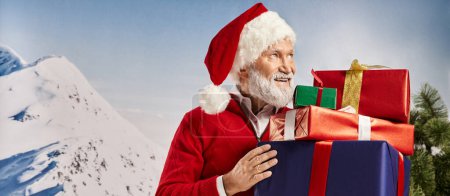 cheerful Santa with christmassy hat holding presents in hands looking away, winter concept, banner