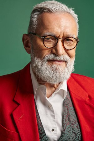 vertical shot of elegant Santa Clous with white beard and glasses looking at camera, winter concept