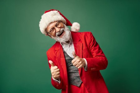 happy jolly Santa showing thumbs up gesture and smiling cheerfully at camera, Christmas concept