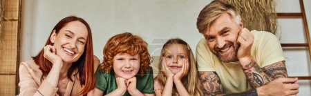 Photo for Cheerful parents and carefree kids lying on bed and looking at camera at home, horizontal banner - Royalty Free Image