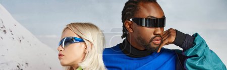 voguish young multicultural couple in stylish sunglasses posing together, winter concept, banner