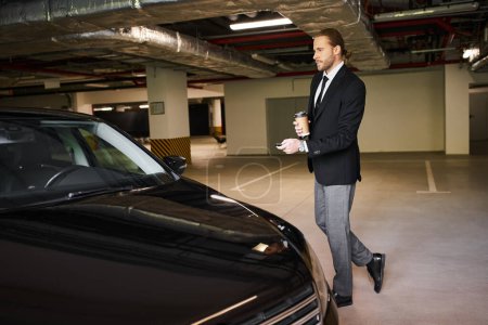 handsome elegant man with exquisite dapper style with coffee cup using car keys, business concept