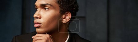 stylish good looking african american male model in evening outfit posing and looking away, banner