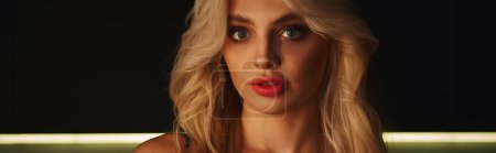 Photo for Beautiful blonde woman in black dress with accessories posing and looking straight at camera, banner - Royalty Free Image