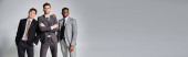 appealing interracial friends in smart business suits posing together on gray background, banner puzzle #685860720