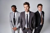 attractive young multicultural male models in business casual attires posing on gray backdrop puzzle #685860810