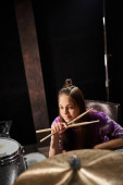 adorable pretty talented teenage girl in vivid attire posing next to drums and looking away puzzle #687124556