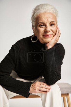 Photo for Business portrait, joyful middle aged business woman in smart casual attire sitting on indoor bench - Royalty Free Image