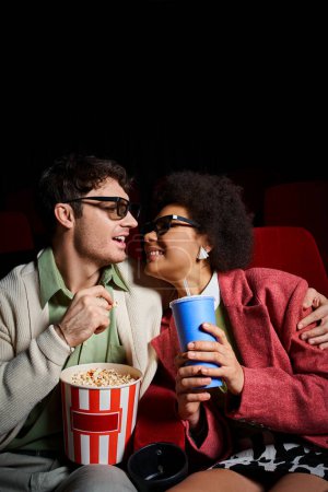 joyful multicultural couple in retro attires smiling joyfully at each other on date at cinema