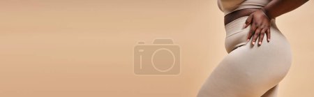 cropped view of plus size african american woman in underwear posing on beige backdrop, banner