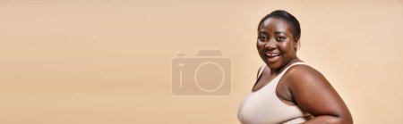 Photo for Cheerful african american plus size woman embracing self-love and confidence, body positive banner - Royalty Free Image