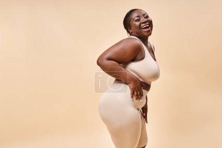 Photo for Cheerful african american plus size woman embracing self-love and confidence, body positive - Royalty Free Image