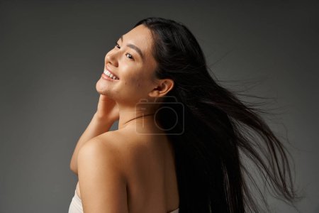young asian woman with brunette hair and acne prone skin looking at mirror in bathroom, banner mug #692761654