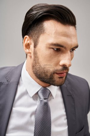 close up photo of worried businessman in formal wear looking away while thinking on grey