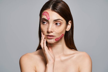 A young Caucasian woman with brunette hair wears a pink face moisturizing patches, promoting self-care and relaxation.