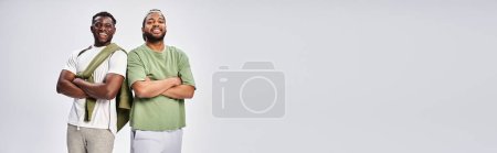 Photo for Unity banner, positive african american friends standing with folded arms on grey background - Royalty Free Image