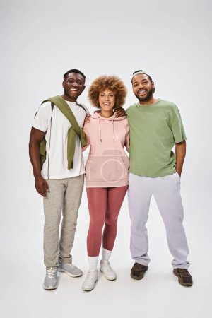 happy african american friends standing and hugging on grey background, Juneteenth celebration puzzle 695321354