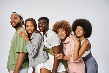 group of positive young african american friends leaning on each other on grey background, community Stickers 695322420