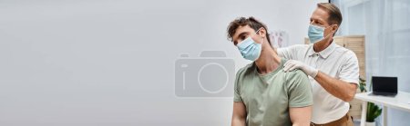 attractive mature doctor with mask helping his patient to rehabilitate in hospital ward, banner