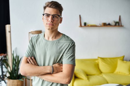 charismatic man in his 20s with brown hair and vision glasses in living room folding cross arms mug #697429644