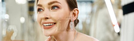 Photo for A young, brunette bride radiates joy in a beautiful white dress at a wedding salon. - Royalty Free Image
