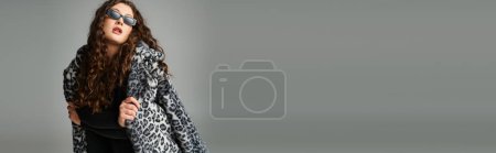 banner of plus size woman in sunglasses leaning forward with leopard fur coat on grey background