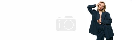 Photo for Alluring sexy woman with blonde hair in unbuttoned suit on white backdrop looking at camera, banner - Royalty Free Image