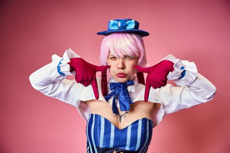 Photo for Good looking sexy woman with red gloves and blue hat showing crying gesture on pink backdrop - Royalty Free Image