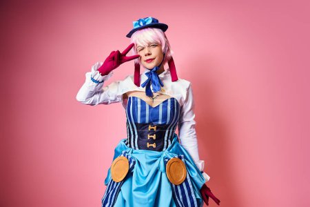 Photo for Joyful young woman cosplaying anime character and showing peace gesture and looking at camera - Royalty Free Image
