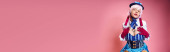 alluring female cosplayer in blue hat and vivid dress looking at camera on pink backdrop, banner Sweatshirt #699817550