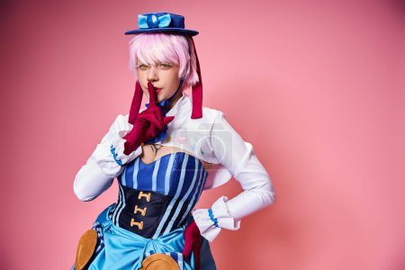 good looking chic woman cosplaying anime character and showing silence gesture on pink backdrop