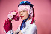 alluring cute female cosplayer in vibrant costume holding pink flowers and looking at camera magic mug #699817966