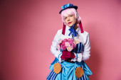 beautiful cute female cosplayer in vibrant costume holding pink flowers and looking at camera puzzle #699818392