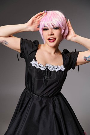 cheerful alluring female cosplayer in vibrant dress sticking out her tongue and looking at camera