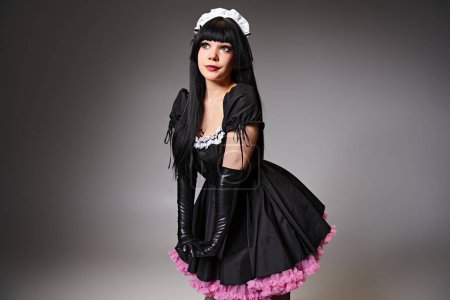 appealing woman in black maid costume cosplaying anime character and looking away on gray backdrop puzzle 699819352