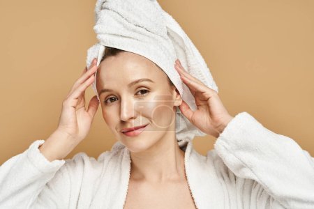 A graceful woman with a towel wrapped around her head, showcasing natural beauty and self-care routine.