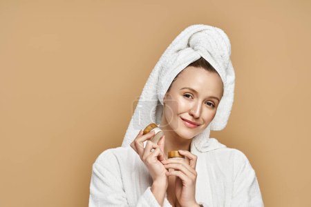A natural beauty holds a pastry with a towel elegantly draped over her head, embodying creativity and elegance.
