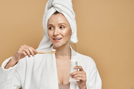 An attractive woman with a towel on her head is actively brushing her teeth.