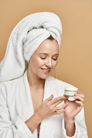 A natural beauty poses gracefully in a bathrobe, holding a jar of cream.