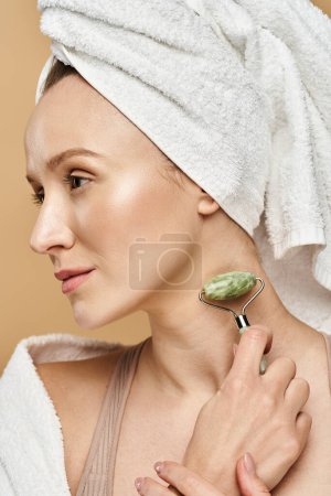 Une femme avec une serviette enroulée autour de sa tête, mettant en valeur la beauté naturelle et la routine d'autosoin.