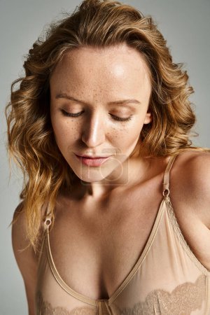 Photo for An attractive woman with her eyes closed, wearing a bra, exudes a sense of calm and beauty. - Royalty Free Image
