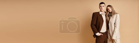 Photo for Young man in elegant suit posing next to his appealing girlfriend who looking at camera, banner - Royalty Free Image
