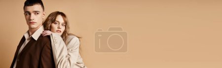 Photo for Young man in debonair suit posing next to his beautiful girlfriend who looking at camera, banner - Royalty Free Image
