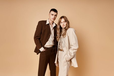 Photo for Elegant young woman in stylish suit posing with her handsome boyfriend and looking at camera - Royalty Free Image