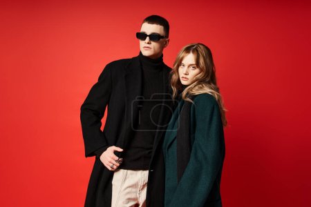 beautiful long haired woman in elegant coat looking at camera near her boyfriend with sunglasses