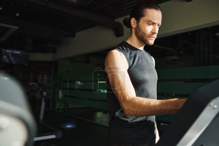 A man in athletic wear is energetically running on a treadmill in a gym.