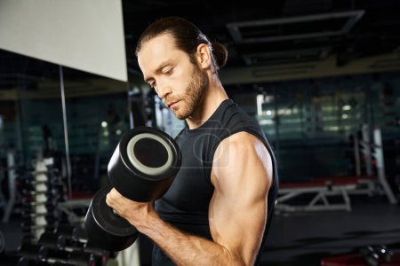 An athletic man in active wear lifts a dumbbell in a gym, showcasing strength and determination in his workout routine.